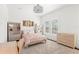 Bright bedroom with cozy carpet, large windows, and comfortable furnishings, creating a warm and inviting atmosphere at 16119 Carencia Ln, Odessa, FL 33556