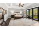 Spacious bedroom with coffered ceiling, wood floor, ceiling fan, and a private balcony at 16119 Carencia Ln, Odessa, FL 33556