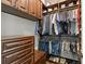 Walk-in closet with custom wood shelving, drawers, and cabinets at 16119 Carencia Ln, Odessa, FL 33556