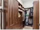 Walk-in closet with custom wood shelving, drawers, and hanging racks at 16119 Carencia Ln, Odessa, FL 33556
