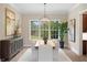 Dining room with a modern chandelier, large window with backyard views, and lots of natural light at 16119 Carencia Ln, Odessa, FL 33556