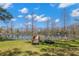 Scenic waterfront view with a wooden dock extending into a peaceful lake at 16119 Carencia Ln, Odessa, FL 33556