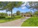 Long paver driveway leads to this elegant home boasting lush lawn, mature landscaping, and a side-entry garage at 16119 Carencia Ln, Odessa, FL 33556