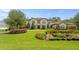 Stunning two-story home features a tile roof, balcony, lush lawn and expertly landscaped garden at 16119 Carencia Ln, Odessa, FL 33556