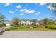 Beautifully landscaped front yard with vibrant flowerbeds and manicured hedges enhancing the curb appeal of this elegant home at 16119 Carencia Ln, Odessa, FL 33556