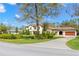 Elegant two-story home with a tile roof and a manicured lawn, presenting an inviting and stately curb appeal at 16119 Carencia Ln, Odessa, FL 33556