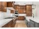 Gourmet kitchen boasts an island, high-end stainless steel appliances, and custom cabinets at 16119 Carencia Ln, Odessa, FL 33556