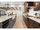 Gourmet kitchen island with stainless steel appliances, marble countertops, and views to living room at 16119 Carencia Ln, Odessa, FL 33556