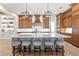 Luxurious kitchen with a large island, custom cabinetry, pendant lighting, and high-end stainless appliances at 16119 Carencia Ln, Odessa, FL 33556