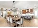 Open concept kitchen and dining area with a large island, hardwood floors, and exposed beam details at 16119 Carencia Ln, Odessa, FL 33556