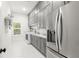 Laundry room with stainless steel appliances, gray cabinetry, and ample counter space at 16119 Carencia Ln, Odessa, FL 33556