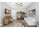 Inviting living room area with a wooden desk, plush white sofa, and unique patterned rug at 16119 Carencia Ln, Odessa, FL 33556