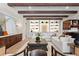 Bright open-concept living room featuring exposed wood beams, built-in shelving, and hardwood floors at 16119 Carencia Ln, Odessa, FL 33556