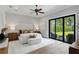 Bright and airy main bedroom with a comfortable bed, modern lighting, and sliding door to the backyard at 16119 Carencia Ln, Odessa, FL 33556