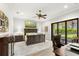 Bright and spacious bedroom with a large bed, ceiling fan, and access to the backyard at 16119 Carencia Ln, Odessa, FL 33556
