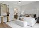 Beautifully designed main bedroom with a luxurious bed, stylish furnishings, and en-suite bathroom access at 16119 Carencia Ln, Odessa, FL 33556