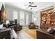 Home office featuring a built-in bookcase, comfortable seating, and a large desk at 16119 Carencia Ln, Odessa, FL 33556