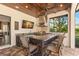 Outdoor kitchen featuring a stainless steel grill, bar seating, and a granite countertop at 16119 Carencia Ln, Odessa, FL 33556