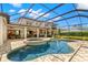 Gorgeous screened-in pool with attached jacuzzi and stone patio, perfect for outdoor entertaining at 16119 Carencia Ln, Odessa, FL 33556