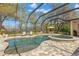 Screened-in pool and spa with brick-paved deck and outdoor seating at 16119 Carencia Ln, Odessa, FL 33556