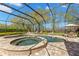Spacious screened-in pool and spa area with brick pavers and ample seating at 16119 Carencia Ln, Odessa, FL 33556