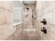 Walk-in shower with bench, rainfall shower head, and bronze fixtures at 16119 Carencia Ln, Odessa, FL 33556