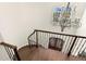 Winding staircase with chandelier, hardwood stairs, and wrought iron banister at 16119 Carencia Ln, Odessa, FL 33556