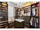 Spacious walk-in closet featuring custom shelving, seating, and a central island for organization and display at 16119 Carencia Ln, Odessa, FL 33556