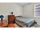 Comfortable bedroom with a twin bed and dresser, offering a cozy and intimate space at 19106 Abercorn Pl, Lutz, FL 33558
