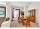 Formal dining area with a chandelier, wooden furniture, and a view towards the front door and living space at 19106 Abercorn Pl, Lutz, FL 33558