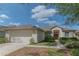 Charming single story home with a well-manicured lawn and attached two car garage at 19106 Abercorn Pl, Lutz, FL 33558