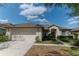 Charming single story home with a well-manicured lawn and attached two car garage at 19106 Abercorn Pl, Lutz, FL 33558