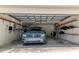 Attached two car garage with high ceilings, storage shelves, and parked SUV at 19106 Abercorn Pl, Lutz, FL 33558
