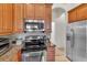 Bright kitchen features stainless steel appliances, granite countertops, and plentiful wood cabinets at 19106 Abercorn Pl, Lutz, FL 33558