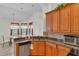 Well-lit kitchen with granite countertops, stainless steel appliances, and view into the dining area at 19106 Abercorn Pl, Lutz, FL 33558
