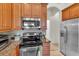 Bright kitchen features stainless steel appliances, granite countertops, and plentiful wood cabinets at 19106 Abercorn Pl, Lutz, FL 33558