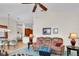 Living room featuring a comfortable sofa with access to the kitchen and dining space at 19106 Abercorn Pl, Lutz, FL 33558