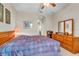 Cozy bedroom featuring wooden furniture, neutral walls, and a glimpse of the ensuite bathroom at 19106 Abercorn Pl, Lutz, FL 33558