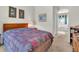 Relaxing bedroom with a wooden bed frame, soft lighting, and a view towards the ensuite bathroom at 19106 Abercorn Pl, Lutz, FL 33558