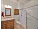 Bathroom featuring a glass enclosed shower, wood vanity, light fixtures, and a tile floor at 1916 Inverness Greens Dr, Sun City Center, FL 33573
