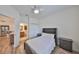 Serene bedroom showcasing wood floors, ensuite access to bathroom, modern decor and a comfortable sleeping space at 1916 Inverness Greens Dr, Sun City Center, FL 33573