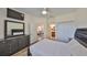 Comfortable bedroom with wood flooring, modern furniture, including a large dresser, and an ensuite bathroom at 1916 Inverness Greens Dr, Sun City Center, FL 33573