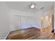 Bright bedroom features a ceiling fan, a hardwood floor and a closet at 1916 Inverness Greens Dr, Sun City Center, FL 33573