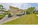 Attractive home featuring a lush green lawn and manicured shrubbery adding to its curb appeal at 1916 Inverness Greens Dr, Sun City Center, FL 33573