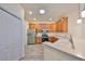Bright kitchen with stainless steel appliances, white countertops, and warm wood cabinets at 1916 Inverness Greens Dr, Sun City Center, FL 33573