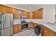Well-equipped kitchen with stainless steel appliances, ample counter space, and warm wood cabinets at 1916 Inverness Greens Dr, Sun City Center, FL 33573