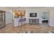 Stylish living space featuring a breakfast bar, modern furnishings, and a large TV, creating a welcoming atmosphere at 1916 Inverness Greens Dr, Sun City Center, FL 33573