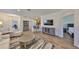 Inviting living room with modern decor, sleek furniture, wood flooring, and a seamless transition to the rest of the house at 1916 Inverness Greens Dr, Sun City Center, FL 33573