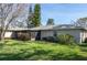 Spacious backyard featuring lush green grass, mature trees, and a screened-in patio area for outdoor living at 2182 Corinne S Ct # C, St Petersburg, FL 33712