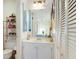 Well-lit bathroom featuring a single vanity, a mirror, and storage in a clean and organized space at 2182 Corinne S Ct # C, St Petersburg, FL 33712
